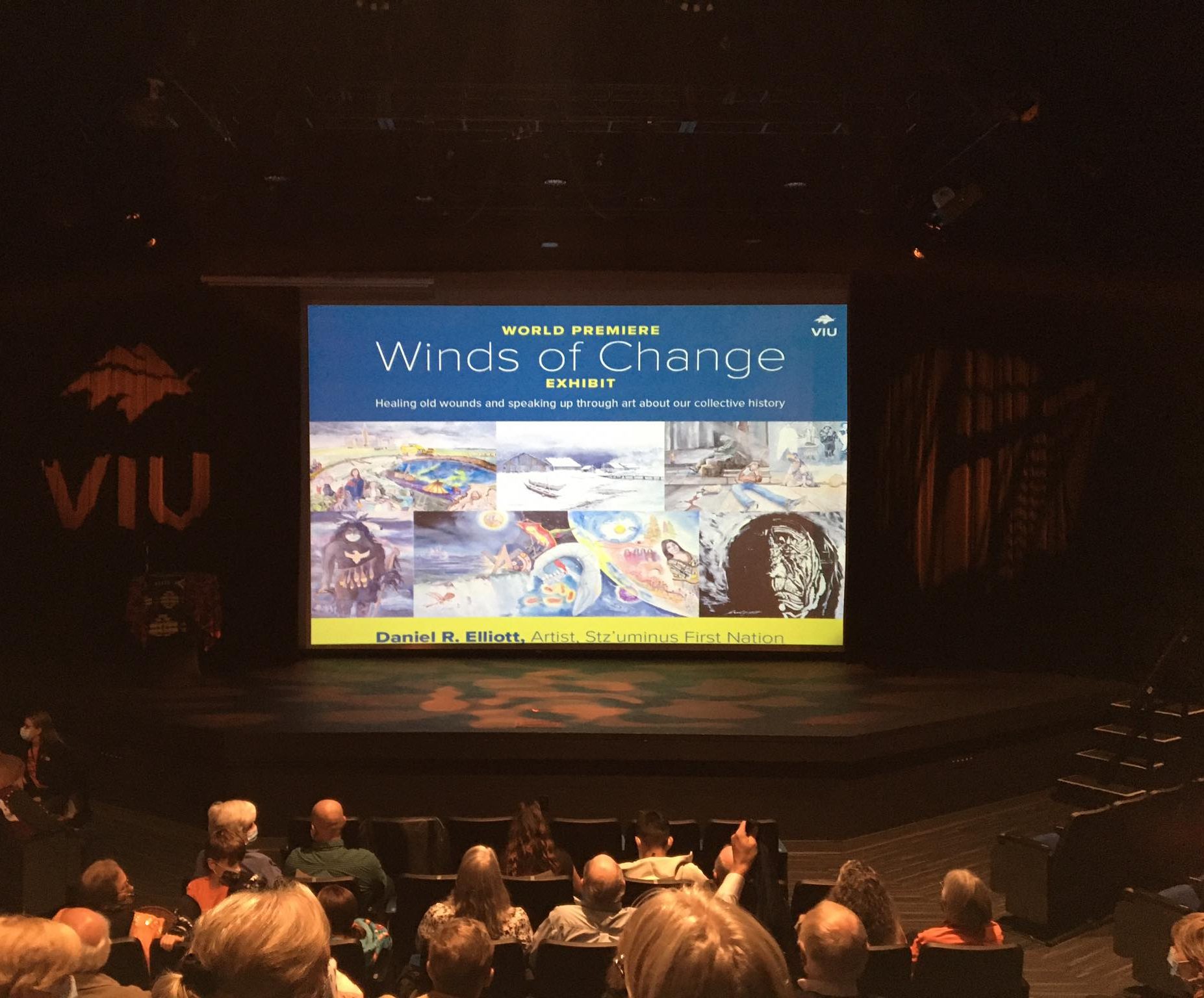 Image shows Winds of Changes poster on theatre stage