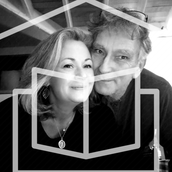 A black and white image of Jack's Parents Tanis Roberts and Don Corfield in a home with a book symbol overlaid.