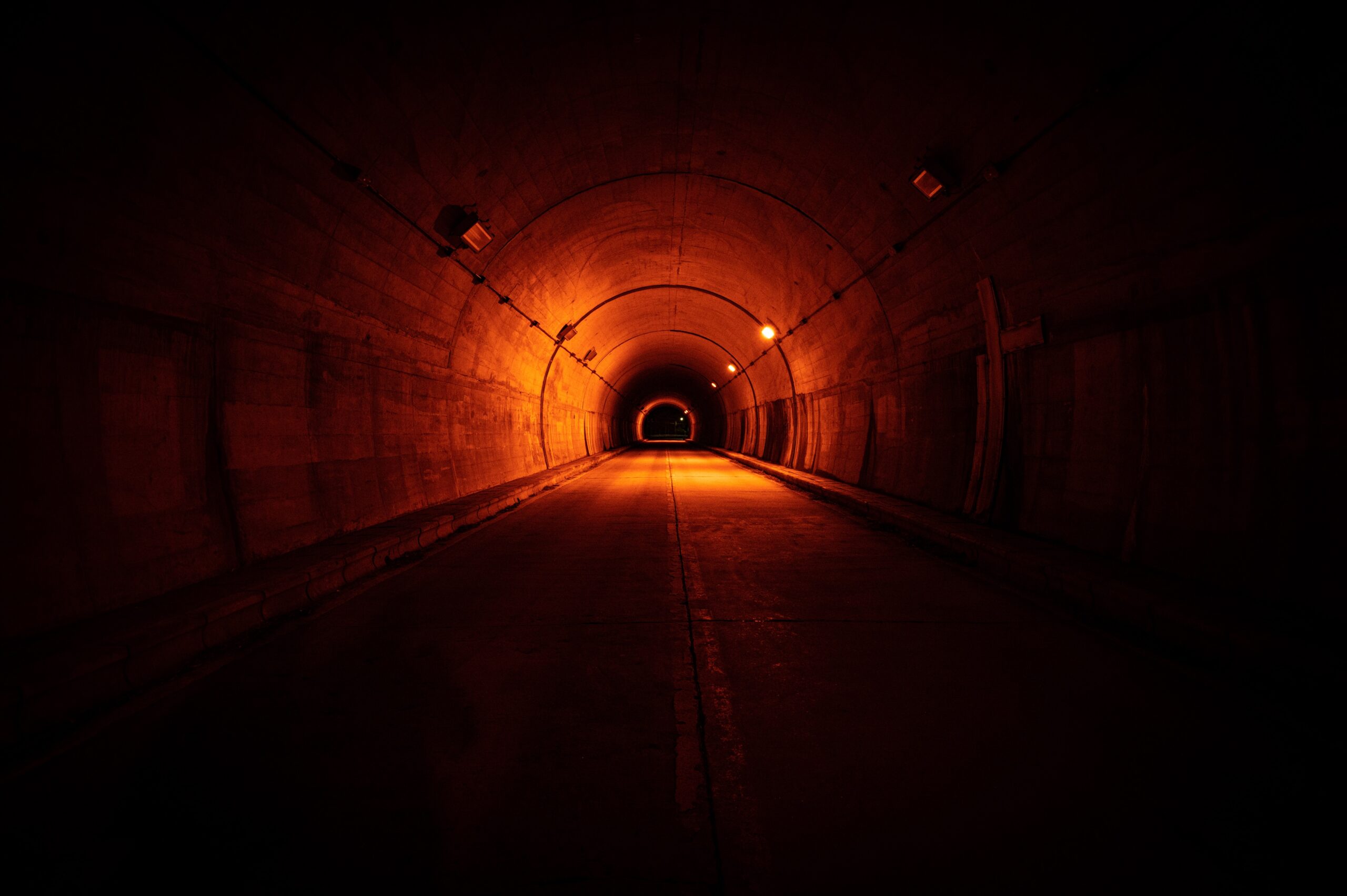 Dark spooky tunnel with low dim orange lights