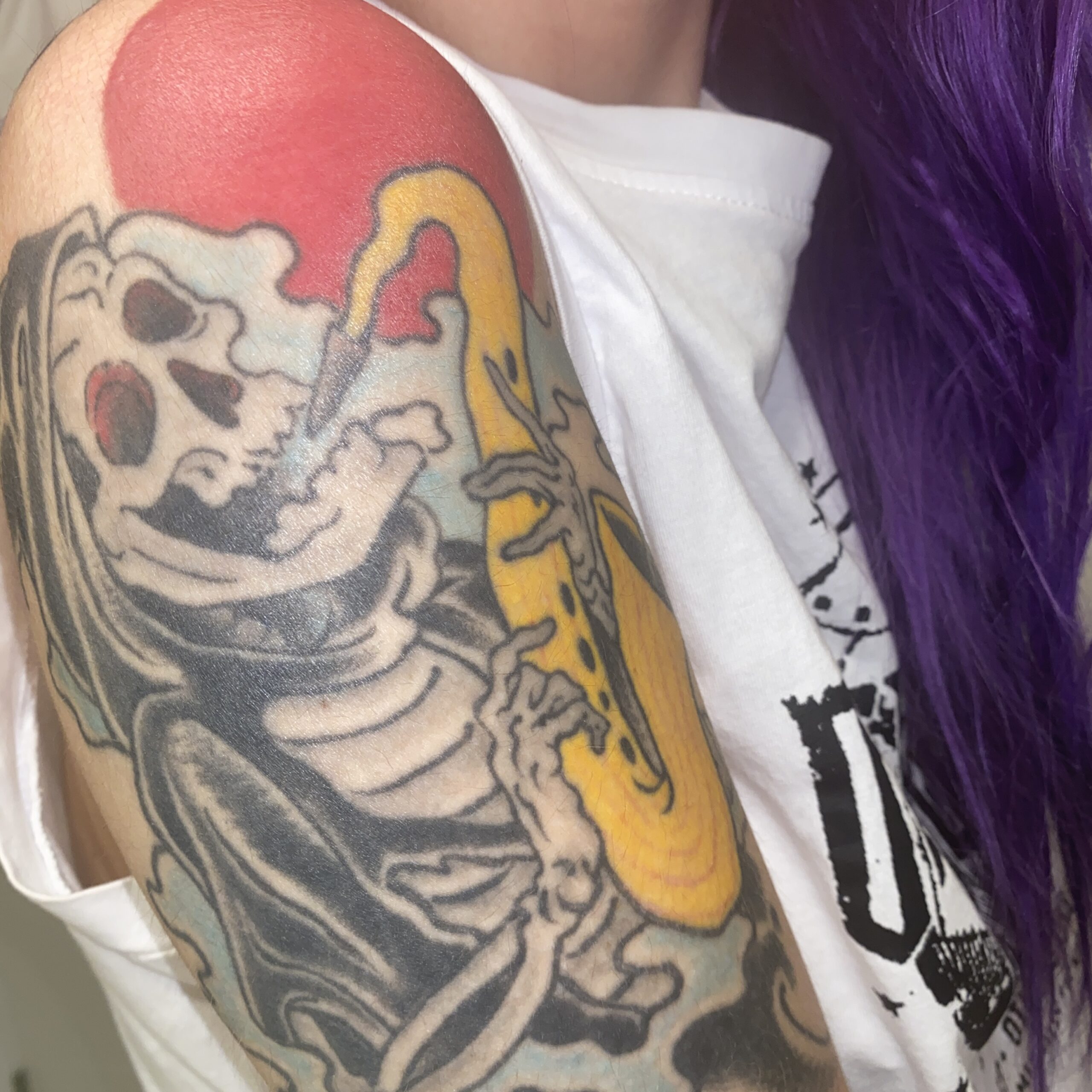spooky tune skeleton tattoo on shoulder