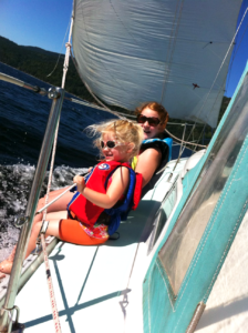 LAUREN AND I, FEET SPLASHING IN THE WATER, LEANING TO THE PORT SIDE DURING A SAIL. PHOTO BY: JEN BAKER (JENAYA’S MUM)